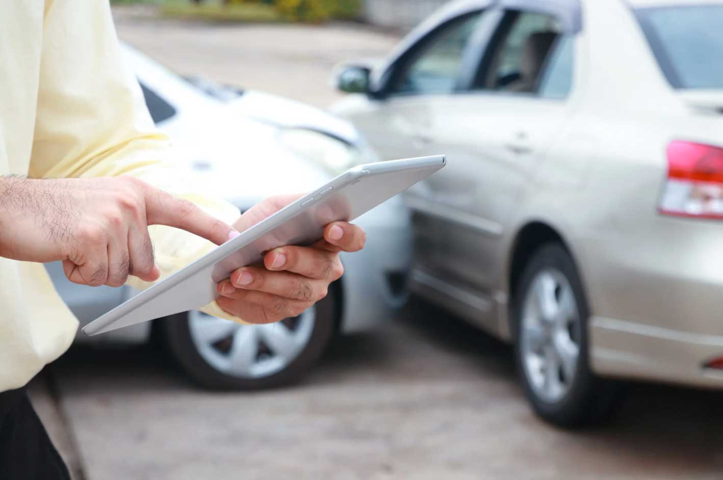 A Car Insurance Adjuster Explaining Coverage After A Car Accident