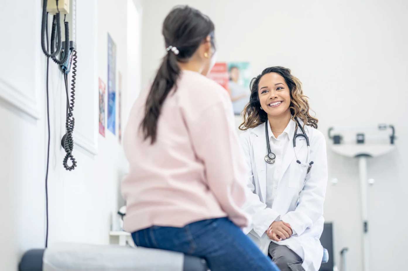 a primary care doctor with a patient during a regular health screening